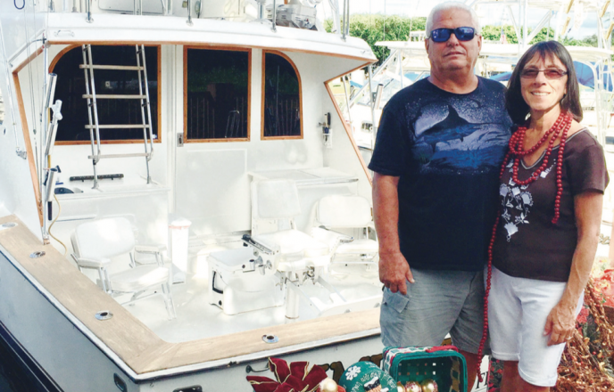 Photo | Carol Jertson Scott and Anita McIlvaine pose in front of their 43-foot Post sport fisherman. They live in Pompano Beach and will participate in three boat parades: Pompano Beach, Boca Raton, and Seminole Hard Rock Winterfest.